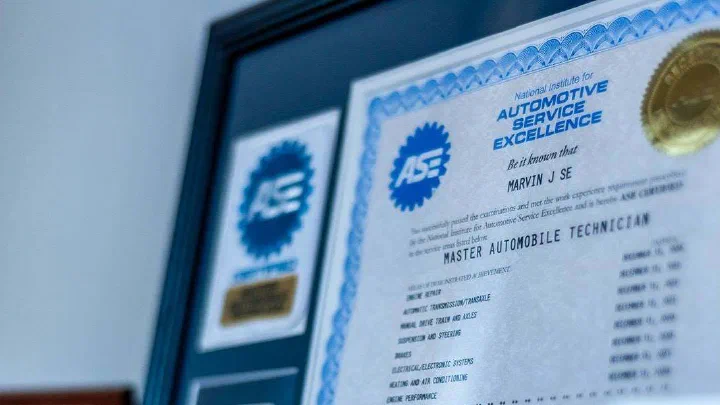 ASE Master Automobile Technician certification displayed in the shop office