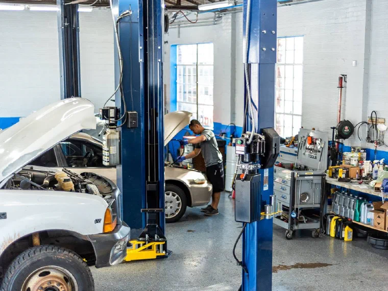 A technician working between the lifts in the Pro-AM Garage service bays